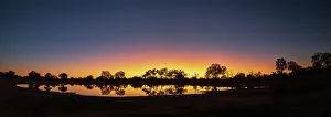 Images Dated 18th August 2022: Colorful sunset at watering hole. Camelthorn Lodge. Hwange National Park. Zimbabwe