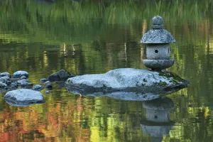 Greg Probst Prints: Concrete lantern on a rock in a pond surrounded by reflections of Fall colors in the water