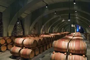 Aging Prints: Concrete Roman arches support the ceiling in the cave barrel cellar of Mission Hill
