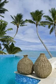 Cook Islands, Rarotonga. Hotel pool surrounded by palm trees