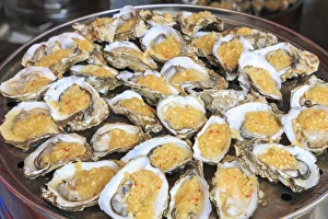 Guangzhou Prints: cooked oysters on a platter, shops around Nine Pedestrian Street, Guangzhou, China