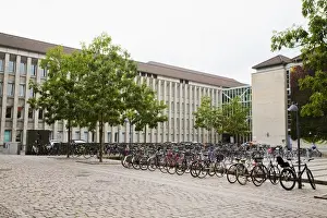 Recreational Activity Prints: Copenhagen, Denmark - A cobblestone street in an Old World city where bicycles are lined up