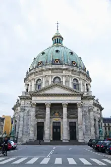 Copy Space Prints: Copenhagen, Denmark - The front of a historic building with columns and a dome. In