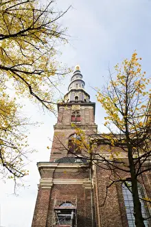 Low Angle Prints: Copenhagen, Denmark - Low angle view of an ornate spire on an old world church. Vertical