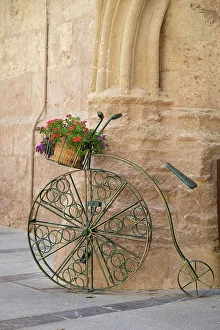 Decorative Prints: Cordoba, Spain. Bicycle planter in front of old stone building