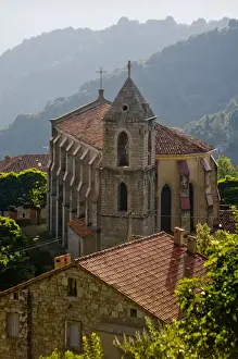 Corsica. France. Europe. Church & house in mountain village of Zicavo above gorge of Molina River