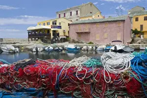 Corsica Prints: Corsica. France. Europe. Fishing nets stacked on dock at village of Centuri. Cap Corse
