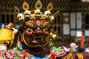 Images Dated 7th April 2009: Costumed dancers at religious festivity with many visitors, Paro Tsechu, Bhutan