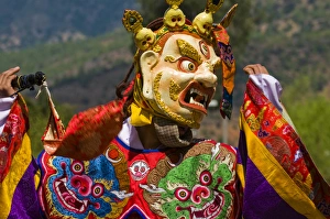Images Dated 7th April 2009: Costumed dancers at religious festivity with many visitors, Paro Tsechu, Bhutan