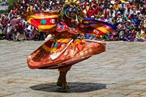 Images Dated 7th April 2009: Costumed dancers at religious festivity with many visitors, Paro Tsechu, Bhutan