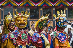 Images Dated 7th April 2009: Costumed dancers at religious festivity with many visitors, Paro Tsechu, Bhutan