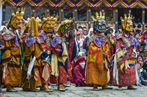 Images Dated 7th April 2009: Costumed dancers at religious festivity with many visitors, Paro Tsechu, Bhutan
