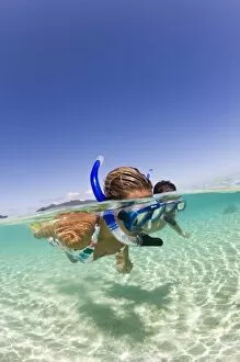Images Dated 8th September 2006: couple (age 23 and 24) enjoying snorkeling the clear tropical waters of a remote island
