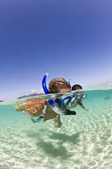 Snorkel Prints: couple (age 23 and 24) enjoying snorkeling the clear tropical waters of a remote island