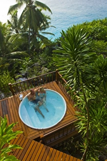 Images Dated 2nd July 2006: Couple enjoying hot tub at Fregate Resort (MR) (PR)