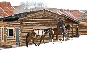 Western Scenic Prints: Cowboy riding a horse with a pack horse on The Hideout Ranch in Shell Wyoming