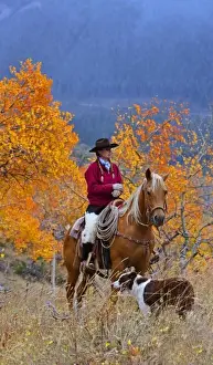 Western Scenic Prints: A cowgirl on her horse with her dog in a fall landscaped area of Shell Wyoming IN the Big Horn MT