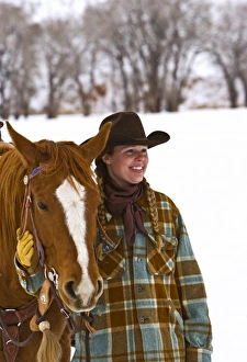 Cowgirl with a horse on the range on The Hideout Ranch in Shell Wyoming