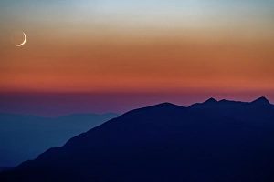 Prints of Crescent moon sets over the Whitefish Range in the Stillwater State Forest, Montana, USA Images Dated 2024 April: Crescent moon sets over the Whitefish Range in the Stillwater State Forest, Montana, USA