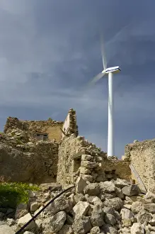 Crete. Greece. Europe. Wind turbine of Plastika Kritis wind farm towers above ruins