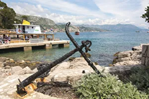 Ferry Prints: Croatia, Dubrovnik. Ferry dock Lokrum Island framed by old anchor