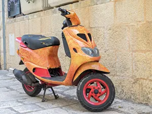 Bicycle Prints: Croatia, Hvar. Bright orange vespa bike in the town of Hvar. (Editorial Use Only)