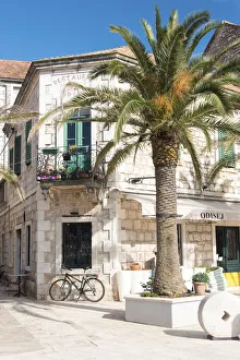 Bicycle Prints: Croatia, Hvar Island, Stari Grad. Uncrowded. Bicycle parked at cafe