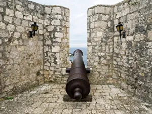 Cannon Prints: Croatia, Hvar. Old cannon overlooking the island town and coastline from Hvar Fortica or Spanjola Fortress