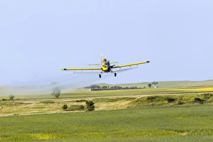 Crop Duster airplane spraying flax filed for grasshoppers near Mott, North Dakota, USA