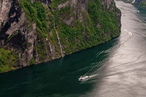 Geiranger Prints: A cruise ship navigates past sheer cliffs in Geirangerfjord, Norway