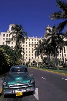Cuba, Havana. Classic 1950s auto in front of Habana Nacional Hotel