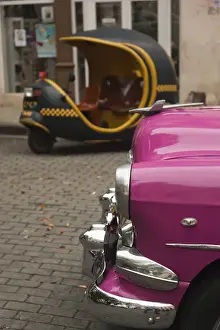 Cuba, Havana, Havana Vieja, morning view of Old Havana street with 1950s-era US car