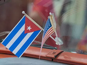 Cuba, Havana, Havana Vieja (Old Havana), Cuban and US flags on dashboard of car