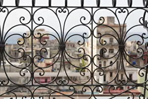 Havana Prints: Cuba, Havana. Late afternoon rainbow and city viewed through wrought iron railing