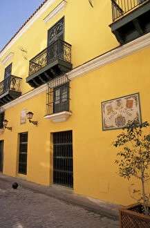Cuba, Havana. Yellow Valencia Hostal wall and architecture