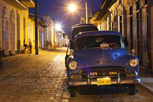 Images Dated 13th March 2012: Cuba, Sancti Spiritus Province, Trinidad, taxis on Calle Antonio Maceo, dusk