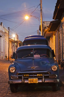 Images Dated 13th March 2012: Cuba, Sancti Spiritus Province, Trinidad, taxis on Calle Antonio Maceo, dusk