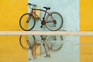 Cuba Collection: Cuba, Trinidad. Bicycle and reflection against yellow and blue walls