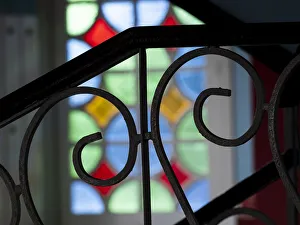 Cuba, Vinales, wrought iron railing and stained glass window Cuba, Vinales, wrought iron railing and stained glass window