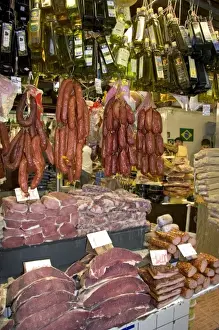 Cured meats, sausages, and olive oil being sold at the Mercado Municipal in Sao Paulo, Brazil
