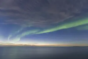Anwr Prints: Curtains of green Aurora Borealis dance over the iceberg dotted surface of the Beaufort