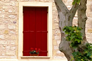 Closed Prints: Dark red shutters in the wall of a house in France