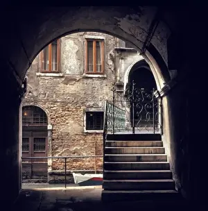Iron Gate Prints: A delicate wrought iron gate marks the entrance to an old home on a small canal in Venice