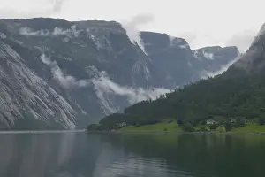 Nordic Prints: departing clouds bend and twist over the dramatic landscape of Eidfjord