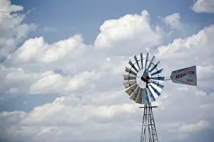 Desert windmill, water tank and horses on land near Hovemweep National Monument, Mesa Verde County