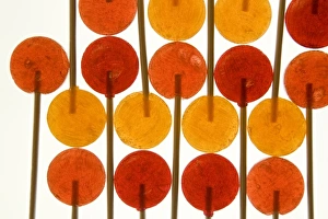 Candy Prints: Design with red and orange lollipop candy on sticks