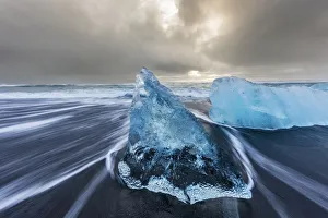 Diamond ice chards from calving icebergs on black sand beach at Jokulsarlon in south