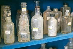 Nostalgia Prints: Dirty antique glass bottles on display, Albuquerque, New Mexico, USA. Central Ave