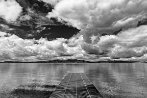 Dock reaches out into Skidoo Bay in Flathead Lake near Polson, Montana, USA