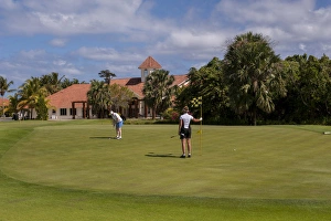 Images Dated 8th March 2011: Dominican Republic, Punta Cana, Higuey, Bavaro, Punta Blanca Golf course, woman putting